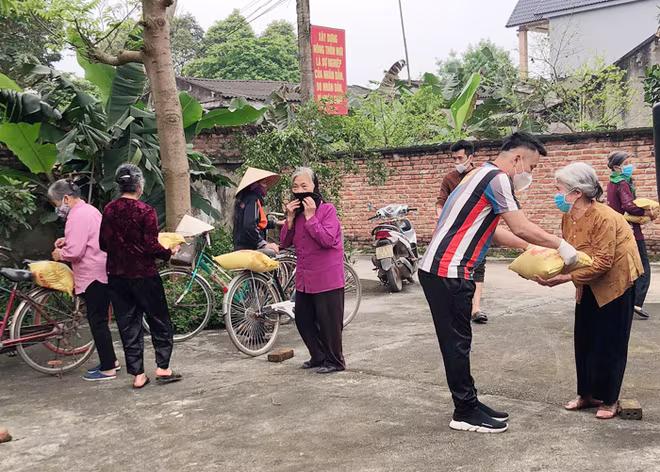 Mọi người đến nhận quà đều khoảng cách an toàn và đeo khẩu trang phòng dịch